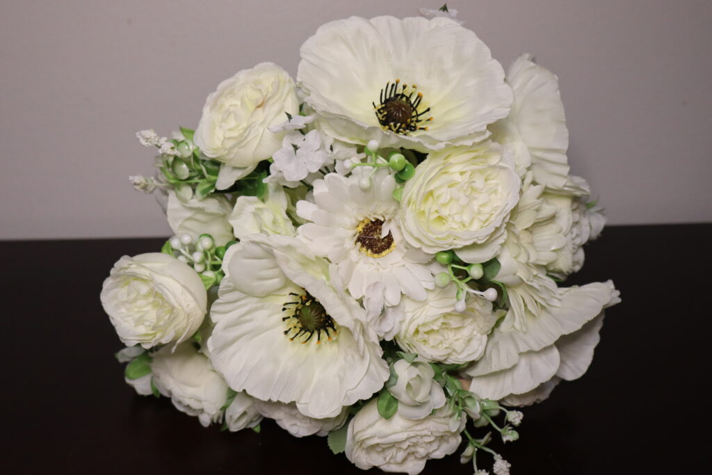 A white custom floral arrangement as a centerpiece.